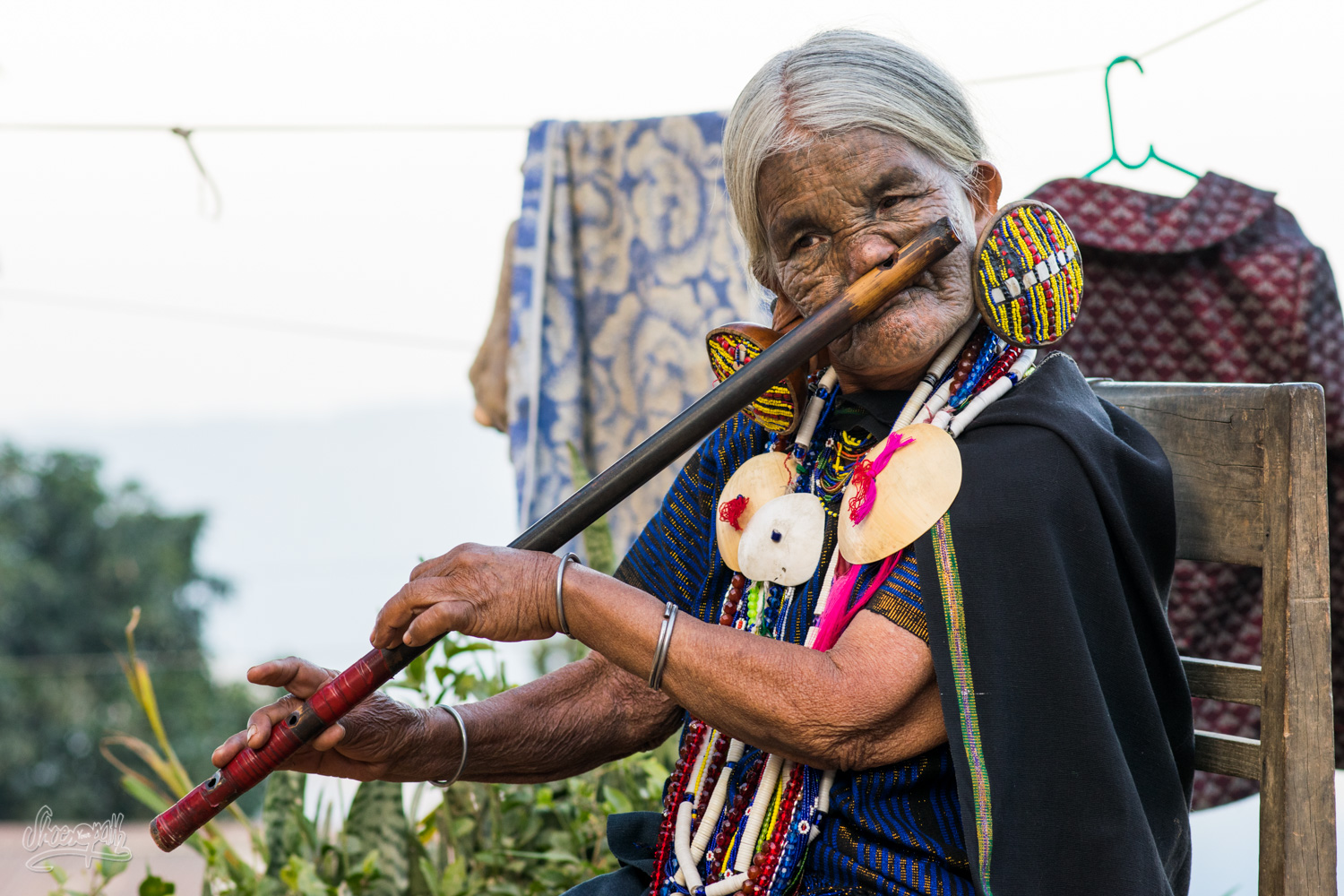 Daw Yaw Hting, 88 years old, one of the last Chin women with a tatoo on her face, playing flute with her nose !