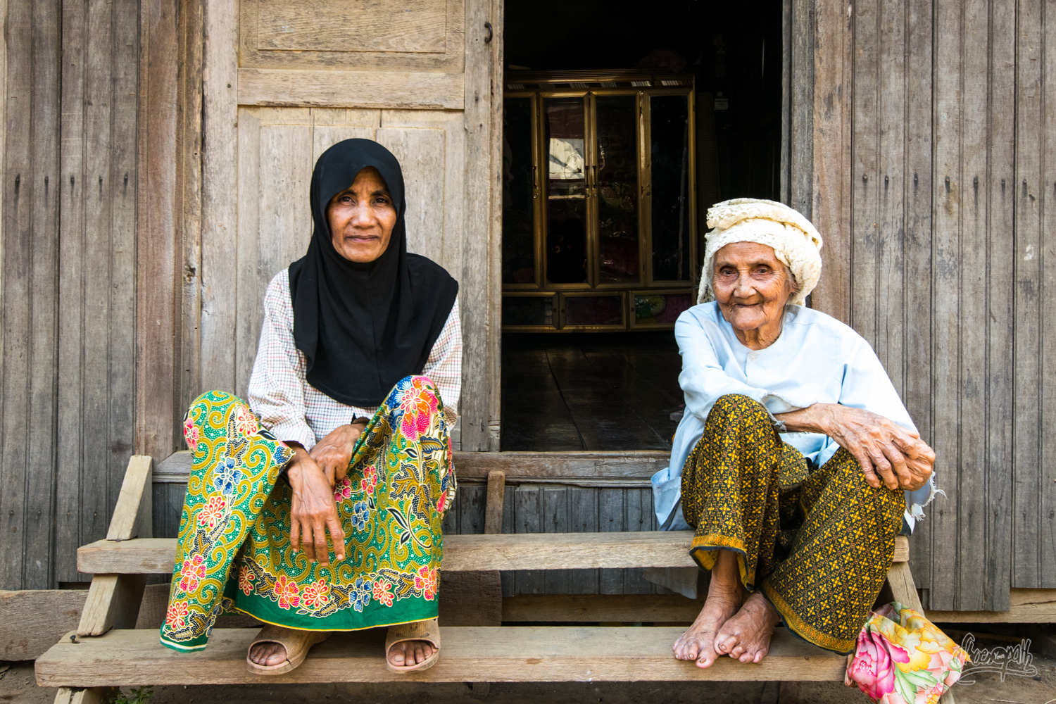 Cham mother and daughter on the door step of their house, just on the banks of the Mekong